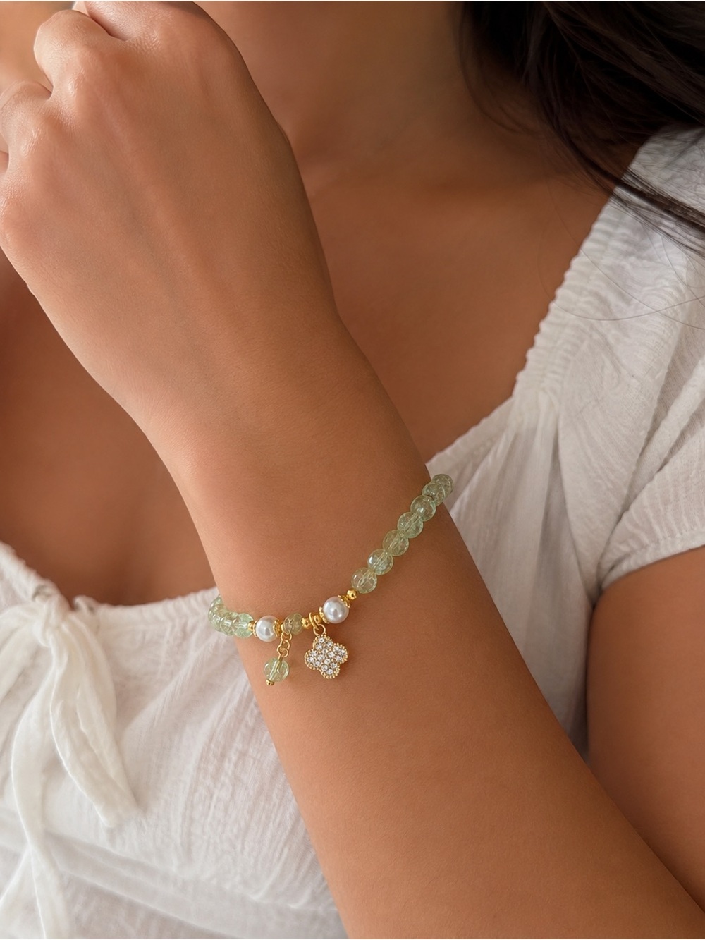 Green beaded bracelet with clover charm